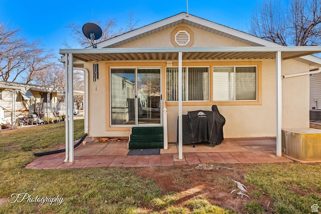 back of house with a yard and a patio area