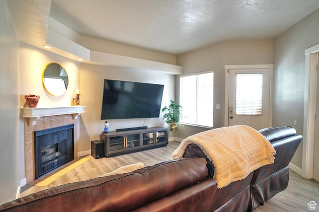 5338 S Beacon Hill Cir W Unit 181, Salt Lake City, UT 84123 - living room with a tile fireplace and light wood-type flooring