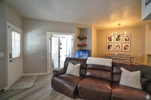 5338 S Beacon Hill Cir W Unit 181, Salt Lake City, UT 84123 - living room with a notable chandelier, a fireplace, light hardwood / wood-style floors, and a textured ceiling