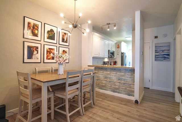 5338 S Beacon Hill Cir W Unit 181, Salt Lake City, UT 84123 - dining area with a notable chandelier and light hardwood / wood-style floors