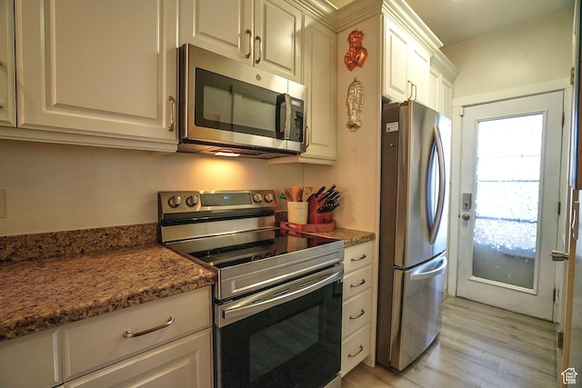 5338 S Beacon Hill Cir W Unit 181, Salt Lake City, UT 84123 - kitchen featuring dark stone countertops, appliances with stainless steel finishes, light hardwood / wood-style flooring, and white cabinets