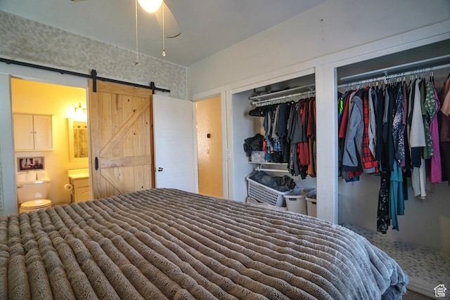 5338 S Beacon Hill Cir W Unit 181, Salt Lake City, UT 84123 - bedroom featuring ensuite bathroom, a barn door, and two closets