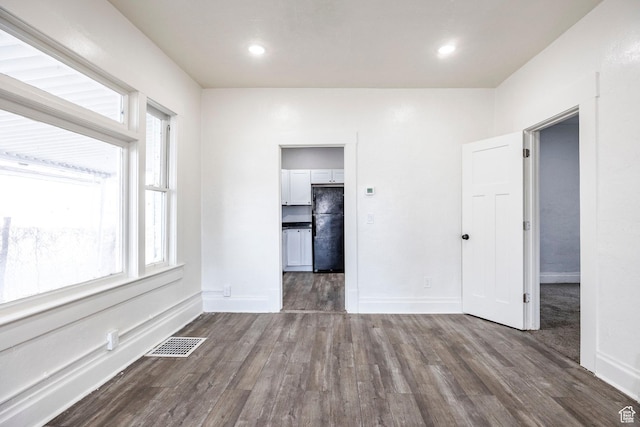 spare room featuring dark hardwood / wood-style flooring