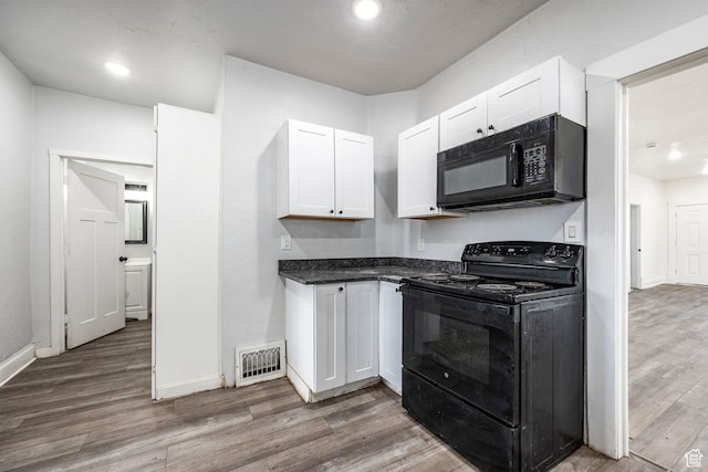 kitchen with white cabinetry, dark hardwood / wood-style floors, and black appliances