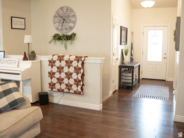 entryway with dark hardwood / wood-style flooring
