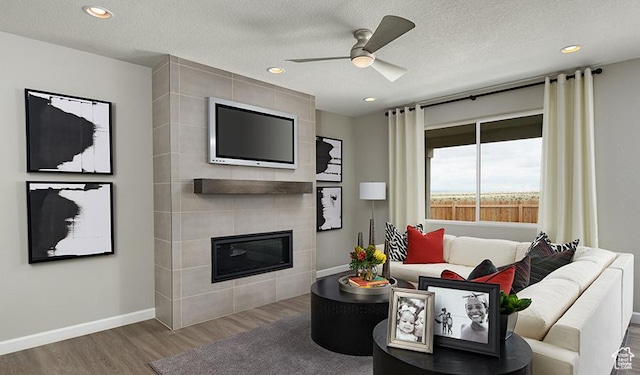 2146 W 3930 S Unit 20, Hurricane, UT 84737 - living room with ceiling fan, a fireplace, hardwood / wood-style floors, and a textured ceiling