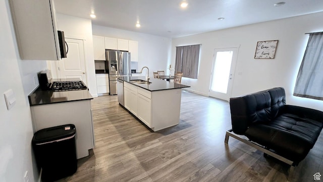 kitchen featuring white cabinetry, sink, an island with sink, and appliances with stainless steel finishes