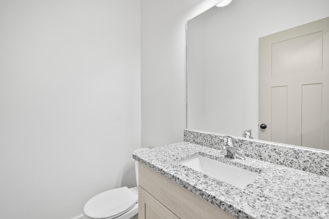half bath with vanity and toilet