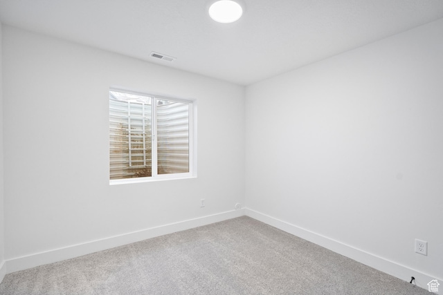 unfurnished room featuring baseboards, carpet, and visible vents