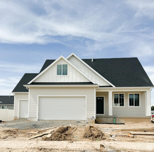 view of front of property featuring a garage, roof with shingles, and board and batten siding