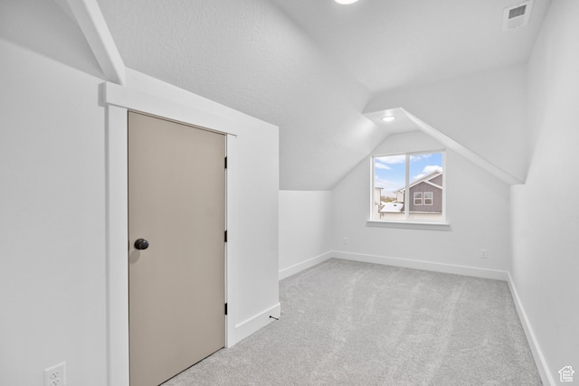 bonus room with visible vents, baseboards, lofted ceiling, and carpet floors