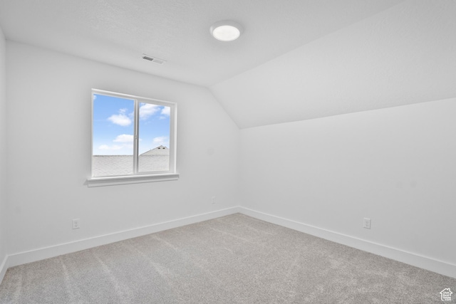 bonus room with visible vents, baseboards, carpet, and lofted ceiling
