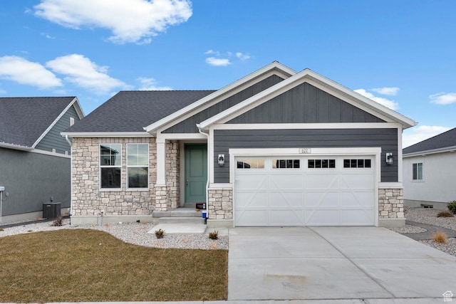 craftsman house featuring central AC unit, a garage, and a front yard