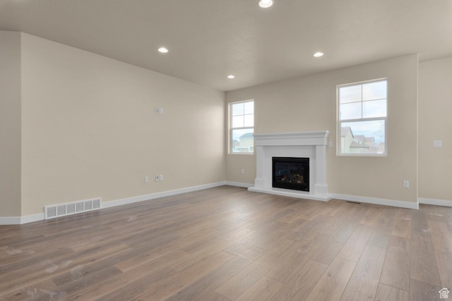622 W Junegrass Ln, Stansbury Park, UT 84074 - unfurnished living room with light wood-type flooring