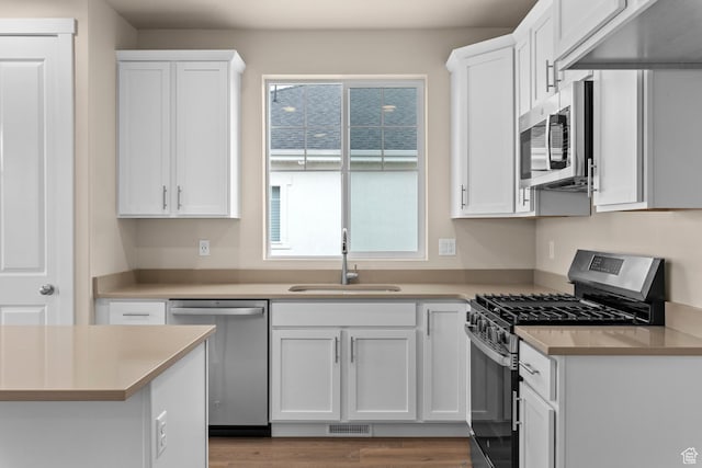 622 W Junegrass Ln, Stansbury Park, UT 84074 - kitchen with dark hardwood / wood-style flooring, sink, white cabinets, and appliances with stainless steel finishes