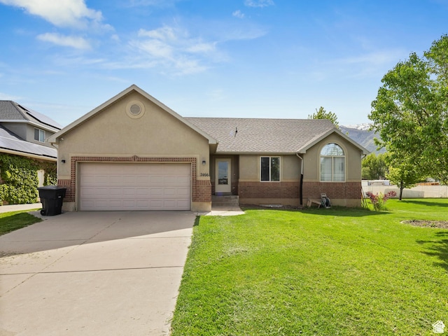 ranch-style home with a garage and a front yard