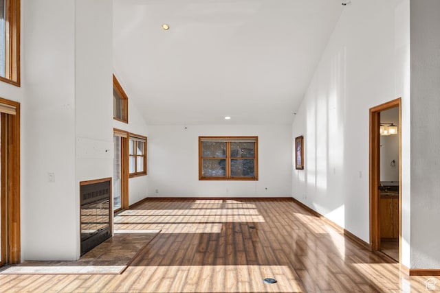 515 Saddle View Way Unit 23, Park City, UT 84060 - unfurnished living room with a healthy amount of sunlight, high vaulted ceiling, and light wood-type flooring