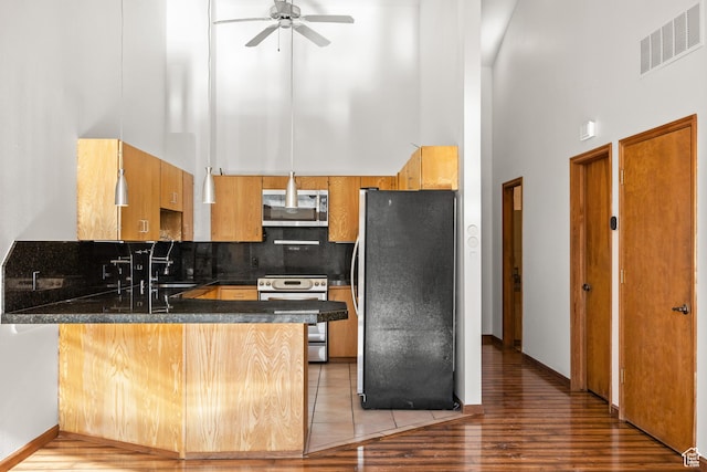 515 Saddle View Way Unit 23, Park City, UT 84060 - kitchen featuring tasteful backsplash, appliances with stainless steel finishes, a high ceiling, and kitchen peninsula