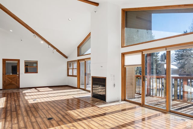 515 Saddle View Way Unit 23, Park City, UT 84060 - unfurnished living room with hardwood / wood-style flooring, a fireplace, high vaulted ceiling, and track lighting