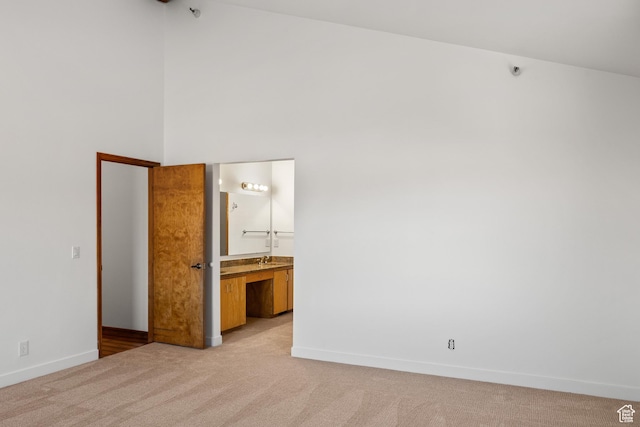 515 Saddle View Way Unit 23, Park City, UT 84060 - unfurnished bedroom featuring ensuite bathroom, light colored carpet, and high vaulted ceiling