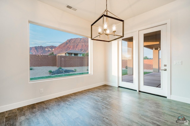 378 W Redstone Ct, Ivins, UT 84738 - unfurnished dining area featuring a chandelier, a mountain view, wood finished floors, visible vents, and baseboards