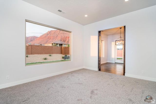 378 W Redstone Ct, Ivins, UT 84738 - carpeted empty room featuring a chandelier, a mountain view, recessed lighting, visible vents, and baseboards