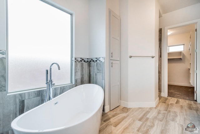 378 W Redstone Ct, Ivins, UT 84738 - bathroom featuring a freestanding tub, a sink, and baseboards