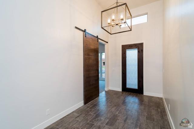 378 W Redstone Ct, Ivins, UT 84738 - foyer featuring dark wood-style floors, a high ceiling, an inviting chandelier, a barn door, and baseboards