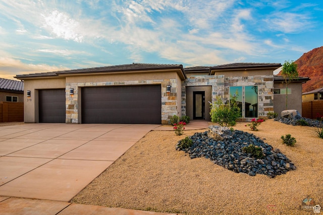 378 W Redstone Ct, Ivins, UT 84738 - prairie-style house with a garage, stone siding, driveway, and stucco siding
