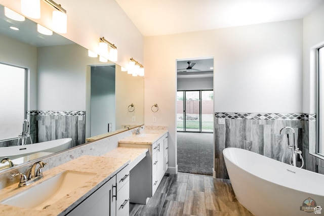 378 W Redstone Ct, Ivins, UT 84738 - full bathroom featuring double vanity, a soaking tub, tile walls, and a sink