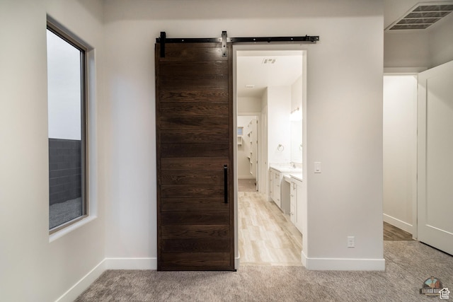 378 W Redstone Ct, Ivins, UT 84738 - corridor with baseboards, a barn door, visible vents, and light colored carpet