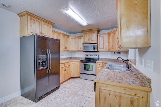 1045 S 1700 W Unit 412, Payson, UT 84651 - kitchen featuring appliances with stainless steel finishes, light brown cabinets, a textured ceiling, light tile patterned floors, and light countertops