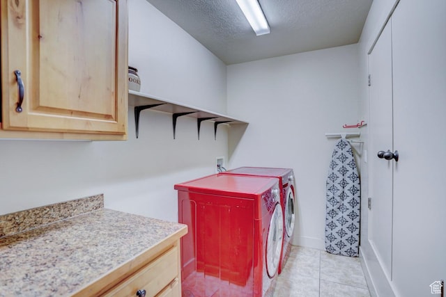 1045 S 1700 W Unit 412, Payson, UT 84651 - laundry area with washer and clothes dryer, cabinet space, a textured ceiling, and light tile patterned flooring