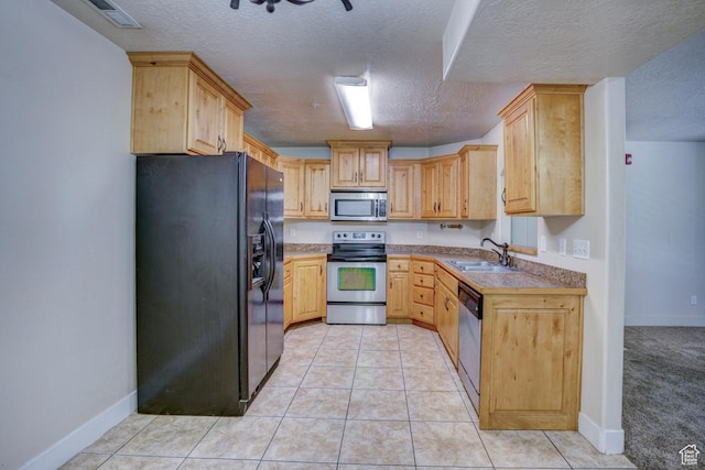 1045 S 1700 W Unit 412, Payson, UT 84651 - kitchen featuring stainless steel appliances, light brown cabinetry, a textured ceiling, and light tile patterned floors