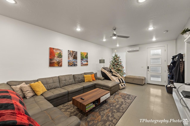 living room featuring ceiling fan and a wall mounted AC