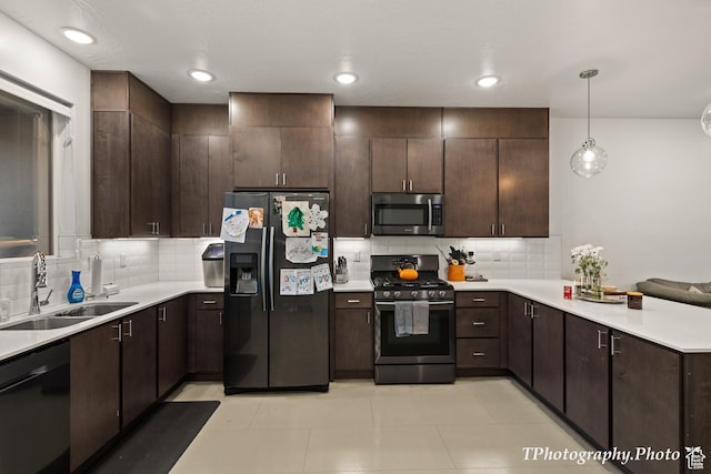 kitchen featuring dark brown cabinetry, sink, appliances with stainless steel finishes, pendant lighting, and backsplash