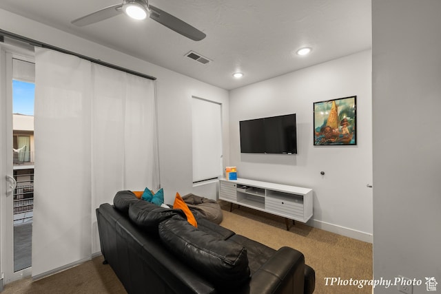 living room featuring carpet floors and ceiling fan