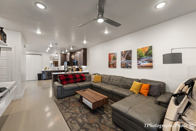 living room featuring sink, a textured ceiling, and ceiling fan