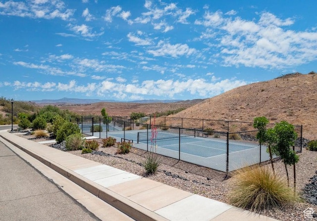 view of tennis court with a mountain view