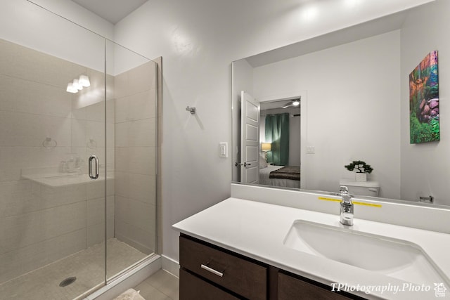 bathroom featuring walk in shower, tile patterned floors, vanity, and toilet