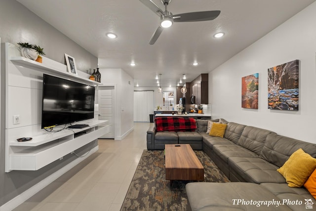living room with ceiling fan and light tile patterned floors