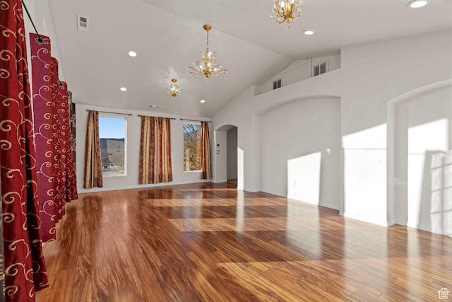 3561 W 290 N, Hurricane, UT 84737 - unfurnished living room with hardwood / wood-style floors, high vaulted ceiling, and a chandelier