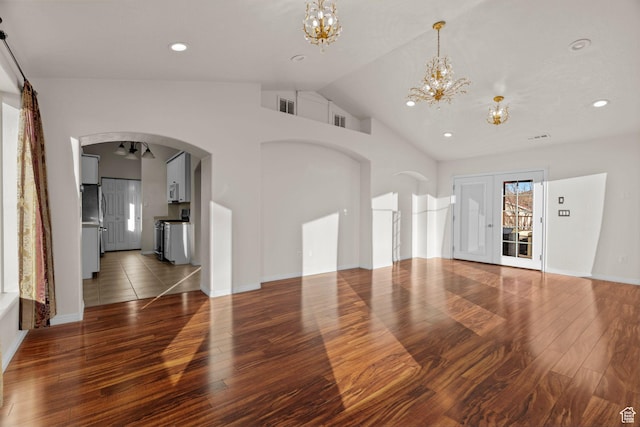 3561 W 290 N, Hurricane, UT 84737 - unfurnished living room featuring an inviting chandelier, lofted ceiling, and dark hardwood / wood-style flooring