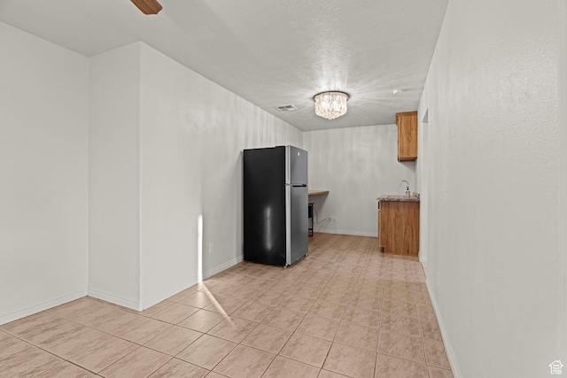 3561 W 290 N, Hurricane, UT 84737 - kitchen with light tile patterned flooring, stainless steel fridge, and a chandelier