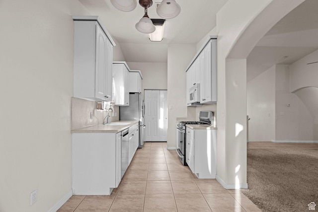 3561 W 290 N, Hurricane, UT 84737 - kitchen featuring sink, light tile patterned floors, appliances with stainless steel finishes, white cabinets, and decorative backsplash