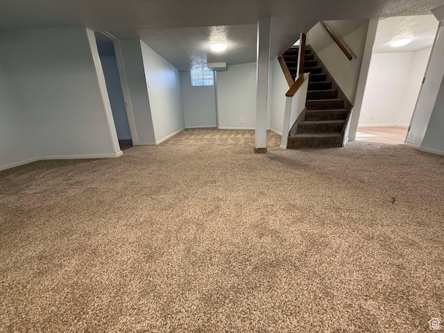 basement with carpet flooring and a textured ceiling