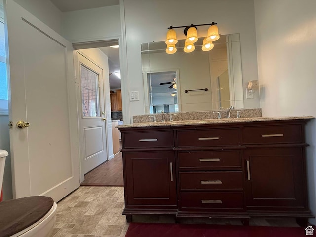 bathroom featuring vanity and toilet