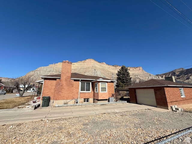 view of front of property with a garage and a mountain view