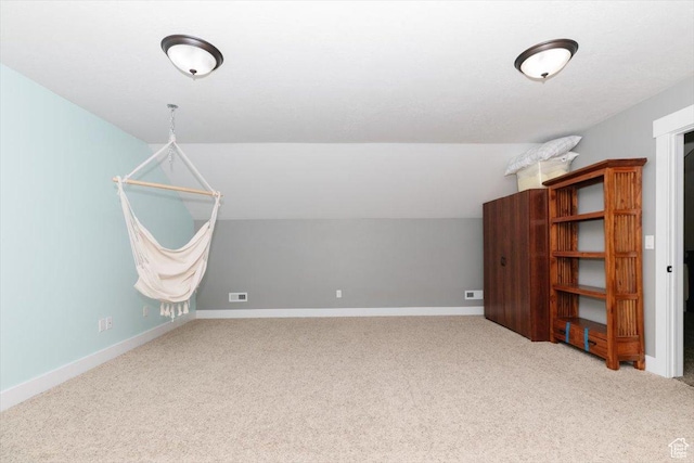 additional living space featuring lofted ceiling and carpet floors