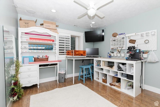 office space featuring ceiling fan, dark wood-type flooring, and a textured ceiling